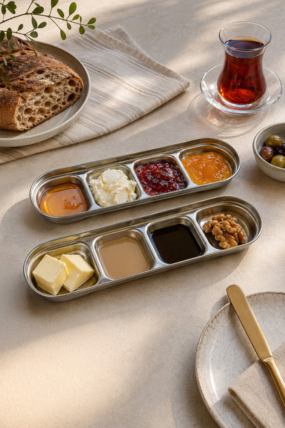 Kahvaltı masasında bal, reçel, tahin, pekmez ve ceviz sunulan gümüş bölmeli kaplar