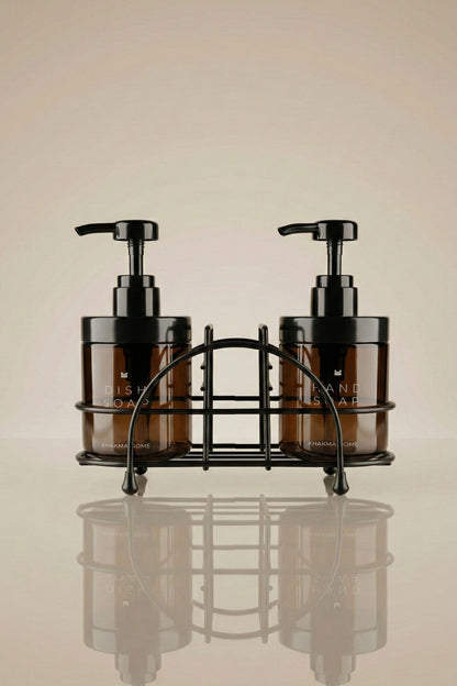 Siyah metal tel stand içinde Dish Soap ve Hand Soap yazılı iki amber cam sabunluk