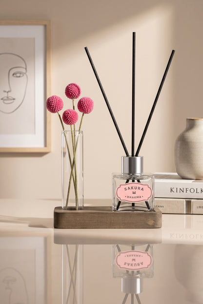 Pembe kuru çiçekli cam tüp ve Sakura difüzör, konsol üzerinde